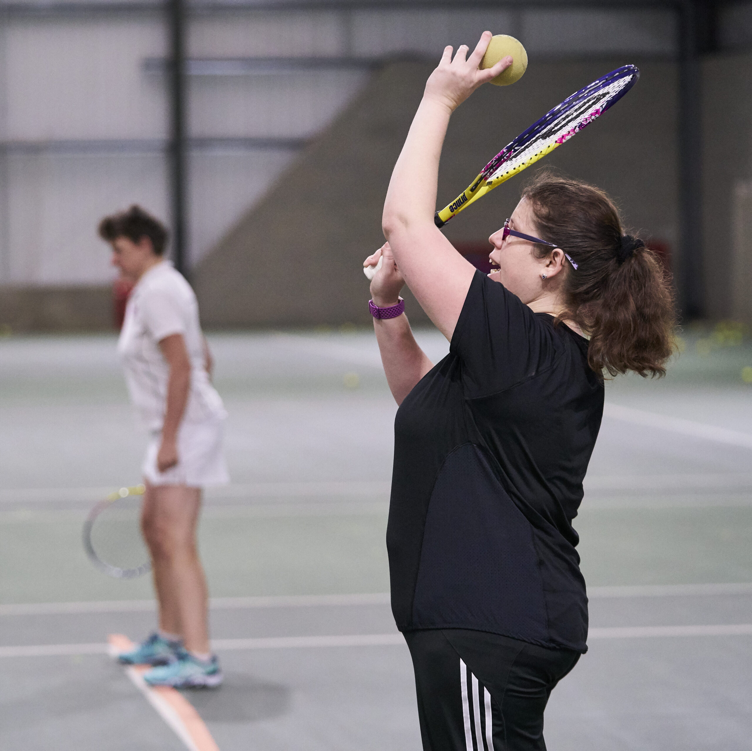 A woman with a disability playing tennis