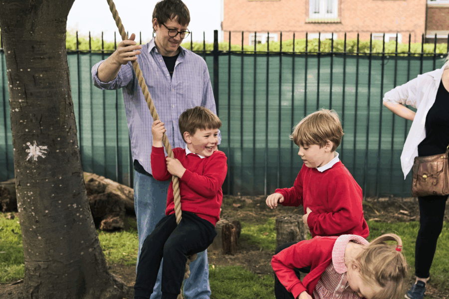 children playing outdoors with their parent/carer