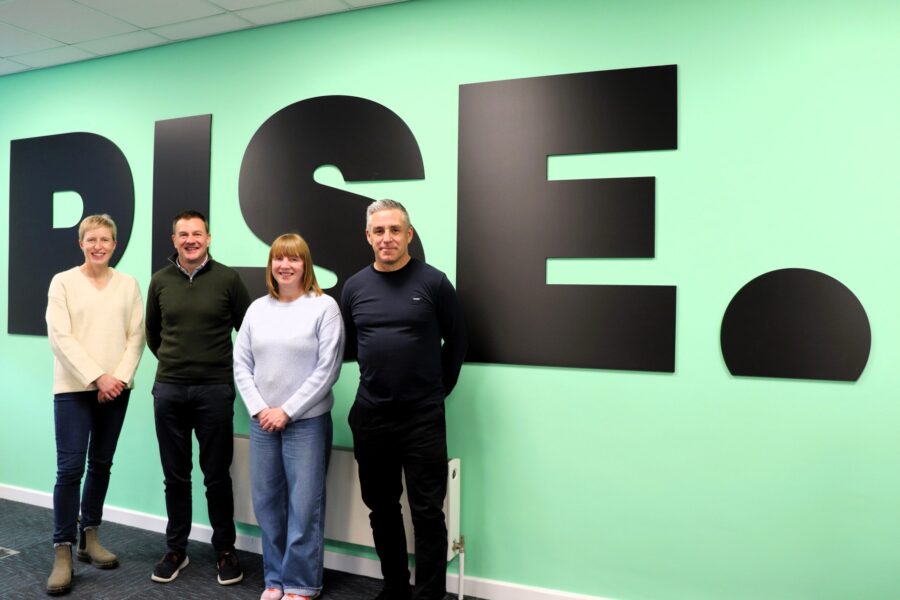 Runners Andy, Chris, and Emma stood alongside Rise CEO Clare Morley, at the Rise office.