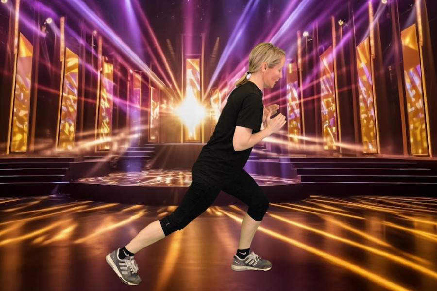 A person in athletic clothing performs a forward lunge on a stage-like background .